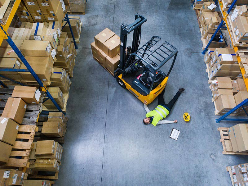 Worker on the floor after falling off forklift